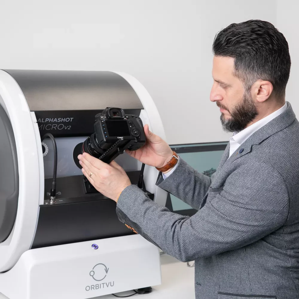 Homme fixant un appareil photo sur Orbitvu Alphashot Micro V2